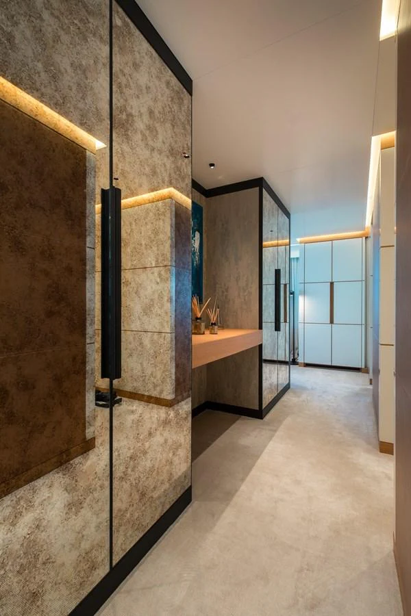 A luxurious hallway with modern decor and ambient lighting. aboard ALCHEMIST Yacht for Sale