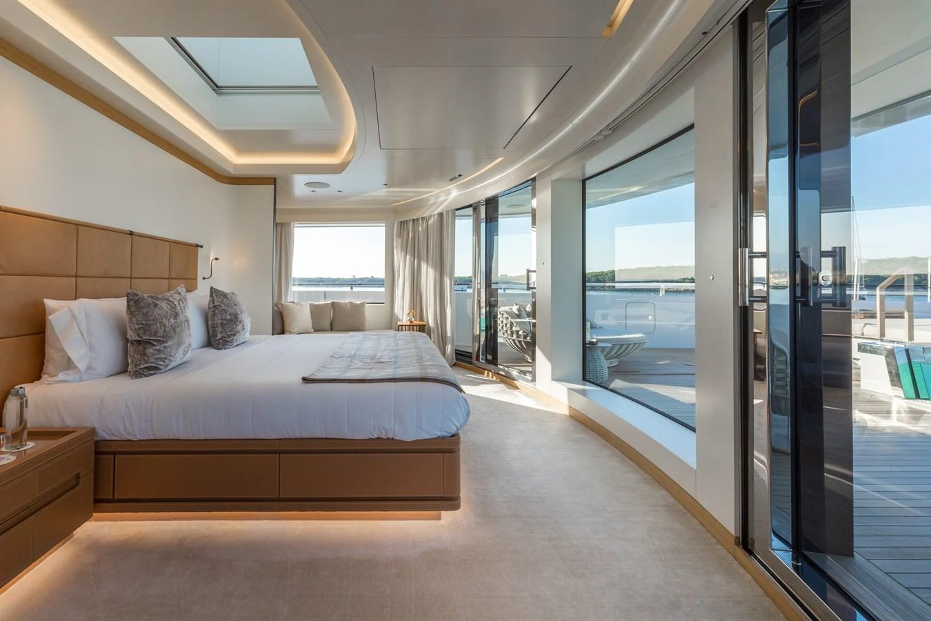 The master stateroom features a spacious layout with large windows offering stunning views and abundant natural light. aboard ALCHEMIST Yacht for Sale