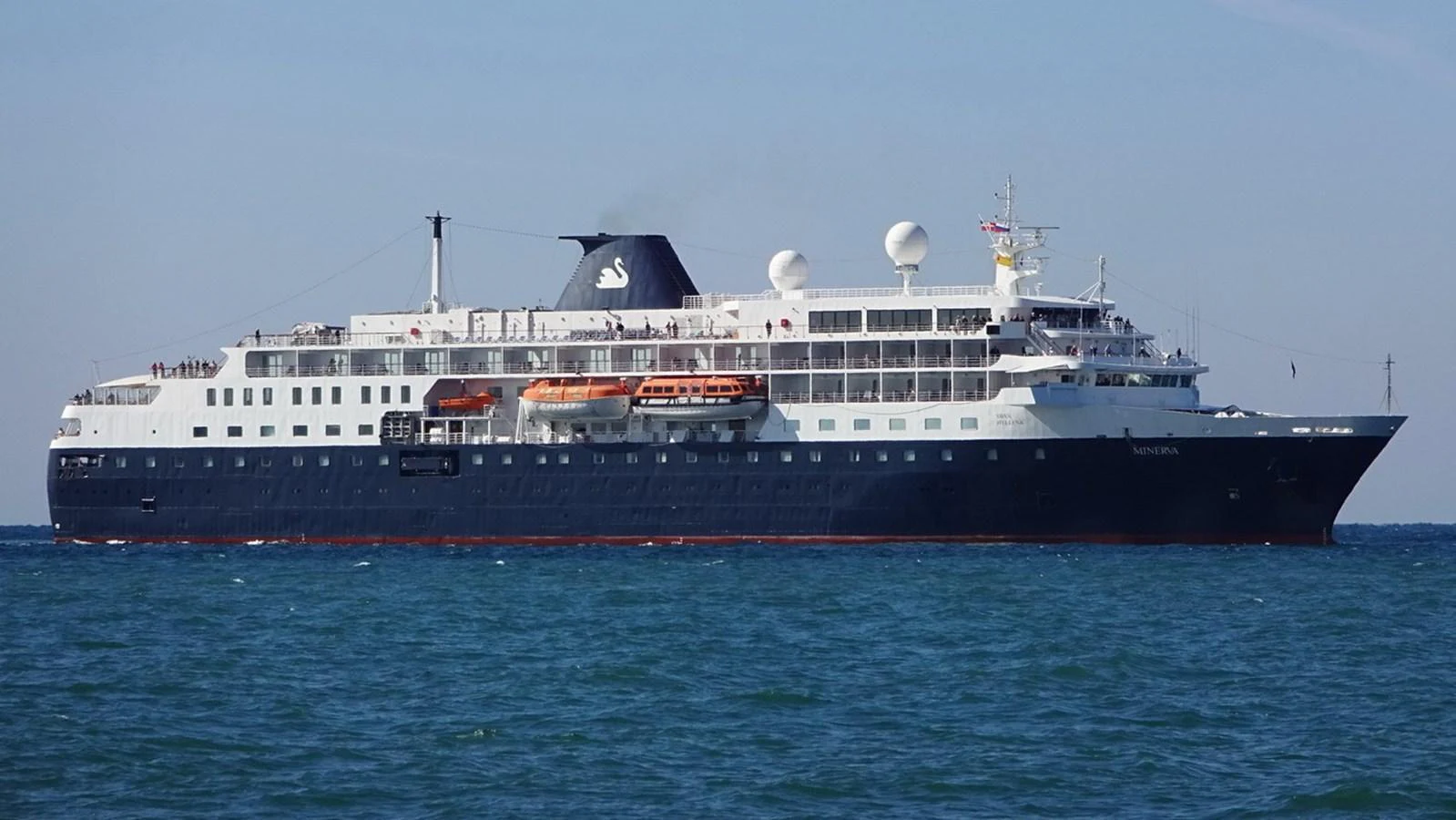 A grand yacht cruises gracefully on the open sea, showcasing its impressive size and elegant design. aboard MINERVA Yacht for Sale