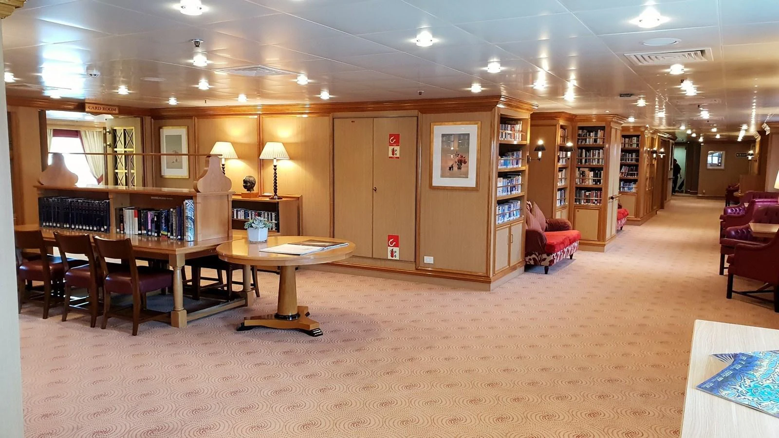 The yacht's library offers a cozy and inviting space for reading and relaxation. aboard MINERVA Yacht for Sale