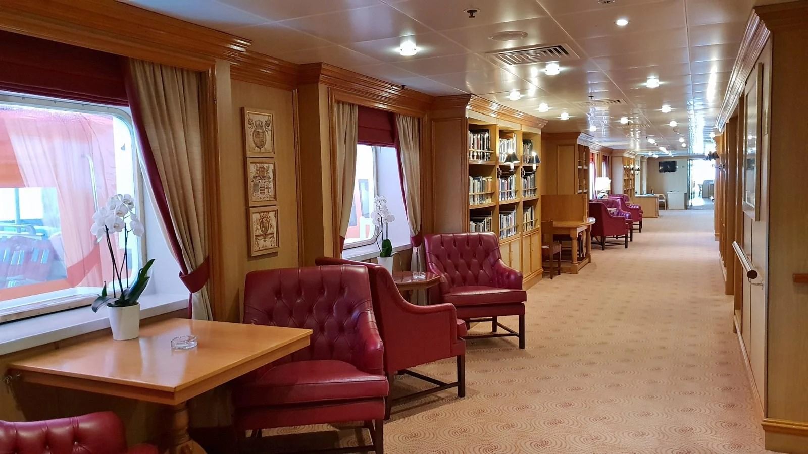 The yacht's interior features a spacious and elegant lounge area with comfortable seating and large windows. aboard MINERVA Yacht for Sale