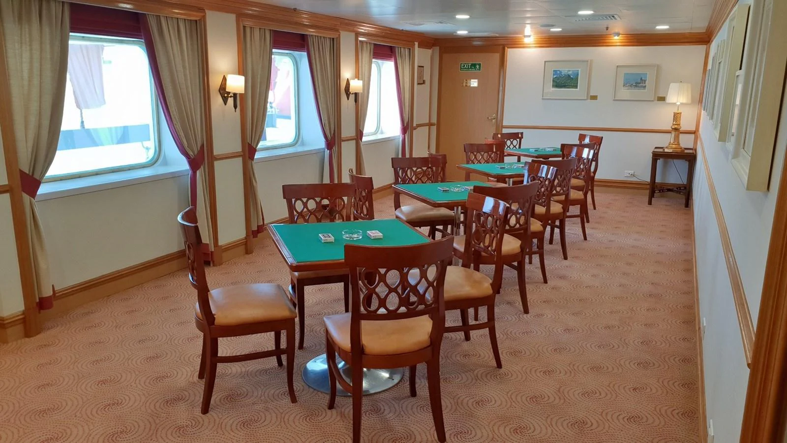 The yacht's game room features elegant wooden furniture and green felt-topped tables, perfect for card games and social gatherings. aboard MINERVA Yacht for Sale
