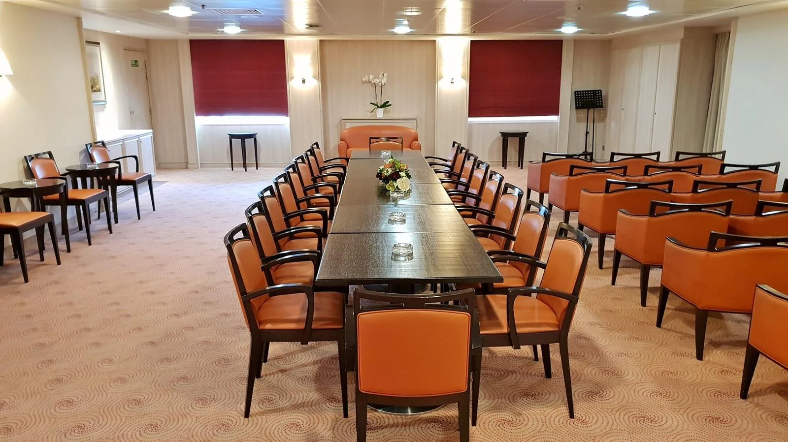 The yacht features a spacious and elegant conference room with ample seating and a sophisticated ambiance. aboard MINERVA Yacht for Sale