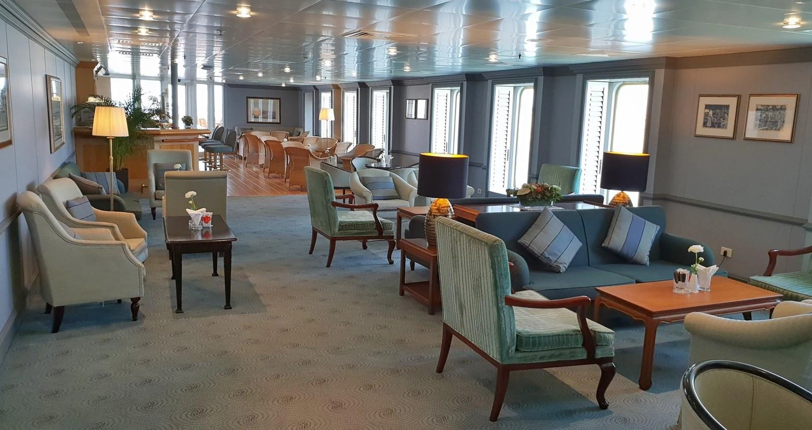 The yacht's interior features a spacious and elegantly furnished lounge area with ample seating and natural light. aboard MINERVA Yacht for Sale