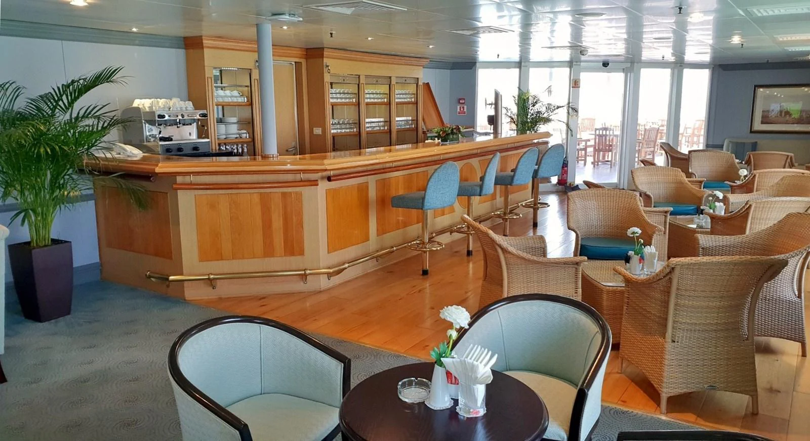 The yacht's interior lounge features a cozy bar area with ample seating and natural light. aboard MINERVA Yacht for Sale