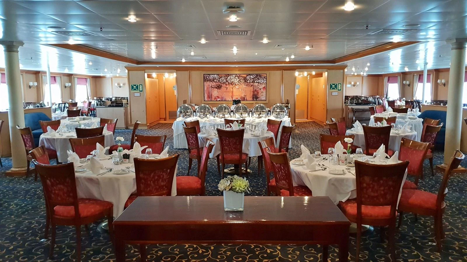 The yacht's elegant dining area features beautifully set tables and comfortable seating, perfect for a luxurious dining experience. aboard MINERVA Yacht for Sale