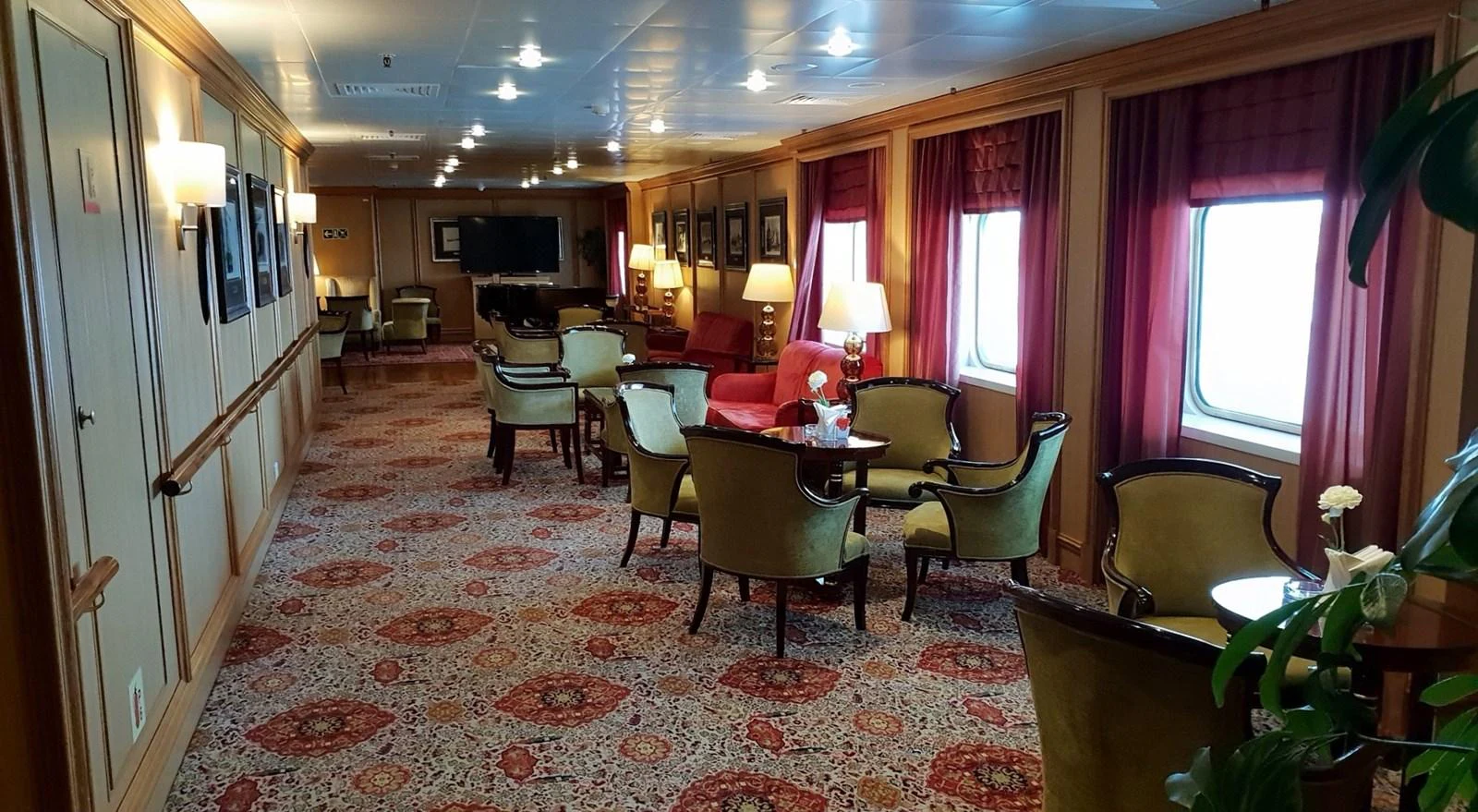 The yacht's interior features a spacious and elegantly furnished lounge area with ample seating and natural light from large windows. aboard MINERVA Yacht for Sale