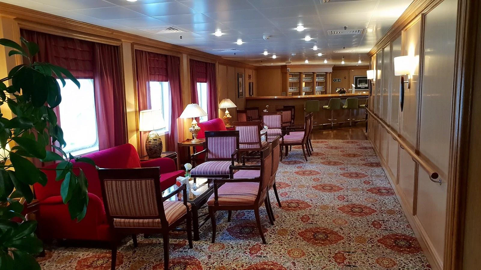 The yacht's lounge area features comfortable seating with a warm and inviting atmosphere. aboard MINERVA Yacht for Sale