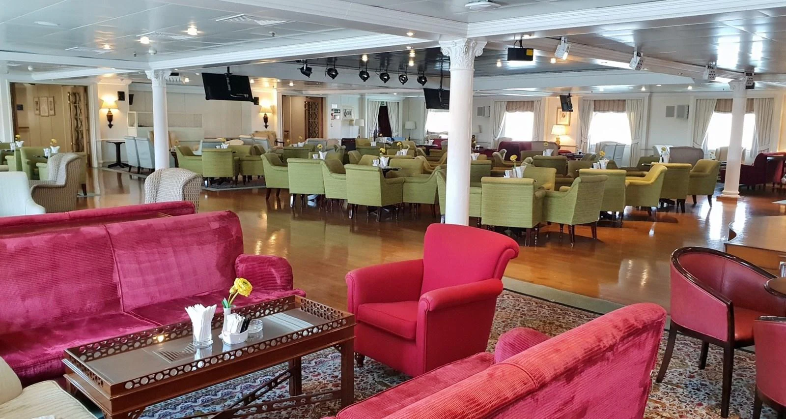 The yacht's interior lounge features comfortable seating with a mix of vibrant and neutral tones, creating a welcoming atmosphere. aboard MINERVA Yacht for Sale