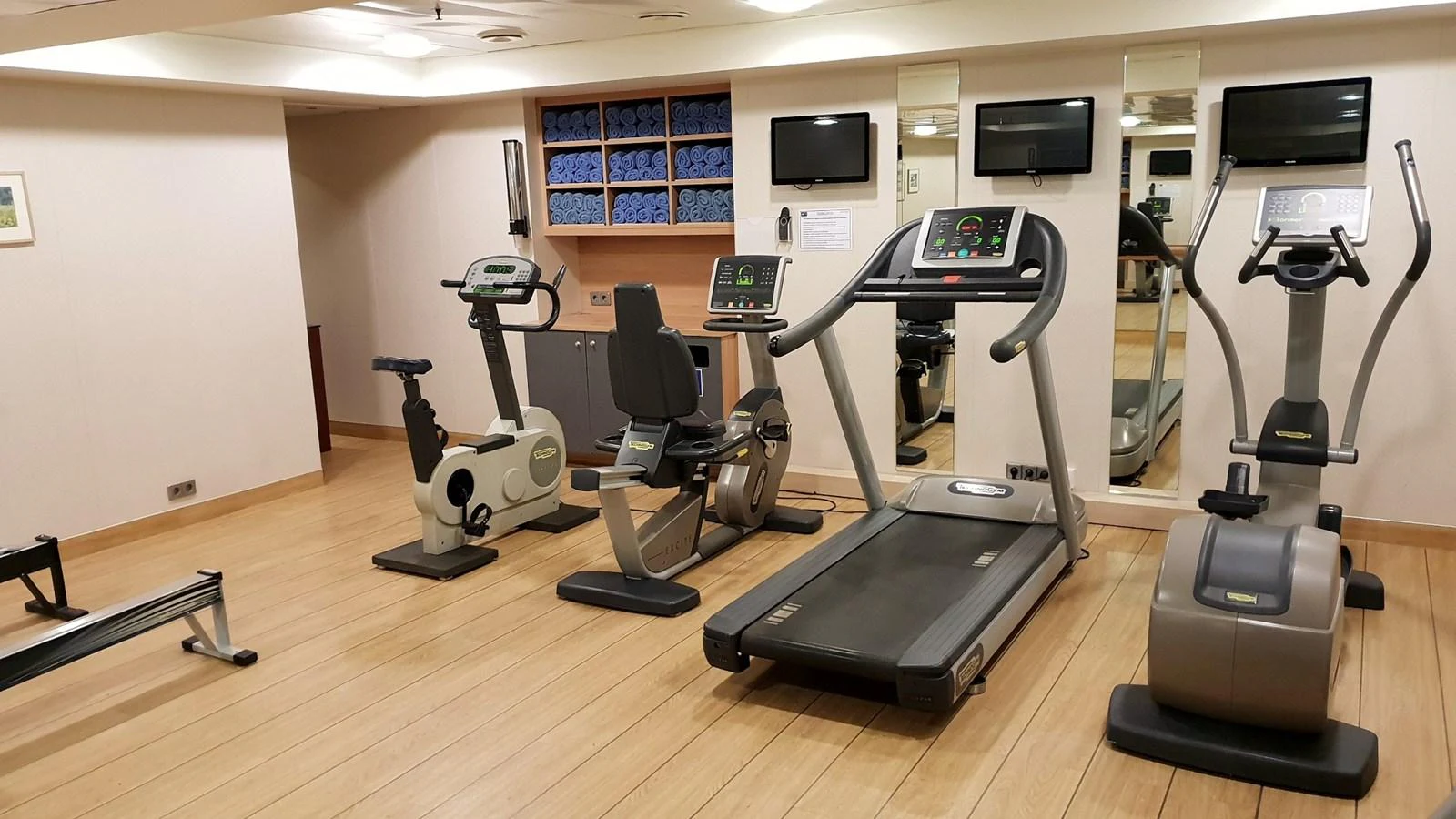 The yacht features a well-equipped gym with modern exercise machines and a mirrored wall. aboard MINERVA Yacht for Sale