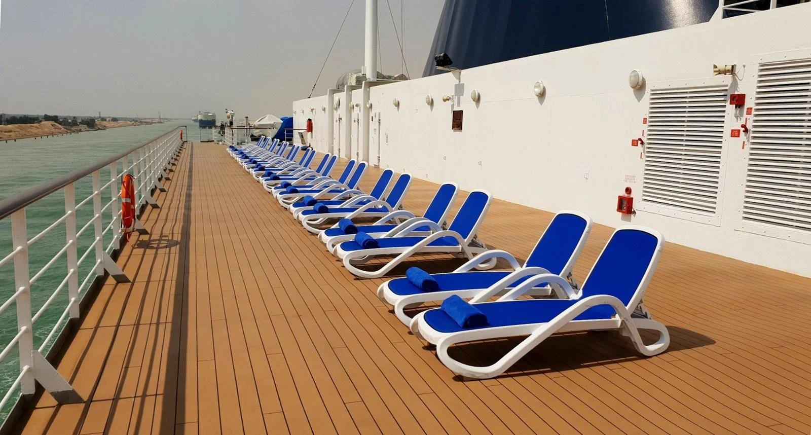 The sundeck features a row of inviting blue lounge chairs, perfect for soaking up the sun. aboard MINERVA Yacht for Sale