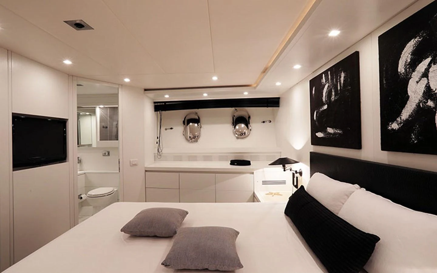 A luxurious stateroom featuring a comfortable bed, modern decor, and an en-suite bathroom. aboard NIKCA Yacht for Sale