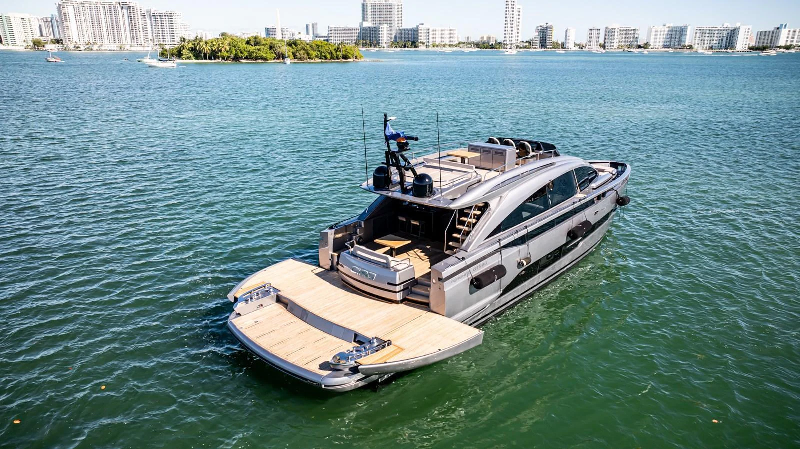 A sleek and modern yacht cruising in a vibrant coastal cityscape. aboard CIAO Yacht for Sale