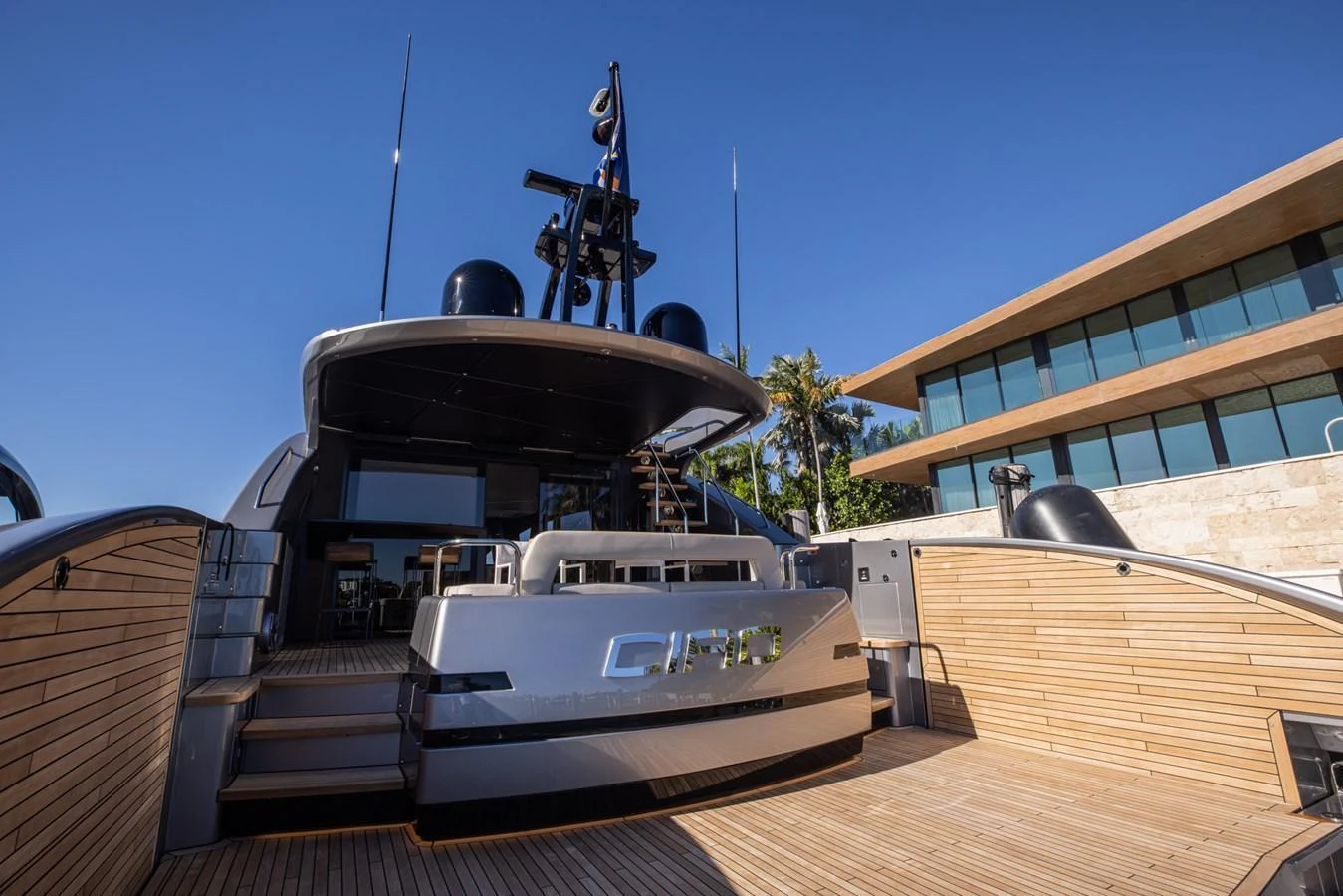 The yacht's aft deck features a spacious and inviting area with elegant wooden flooring and modern design elements. aboard CIAO Yacht for Sale