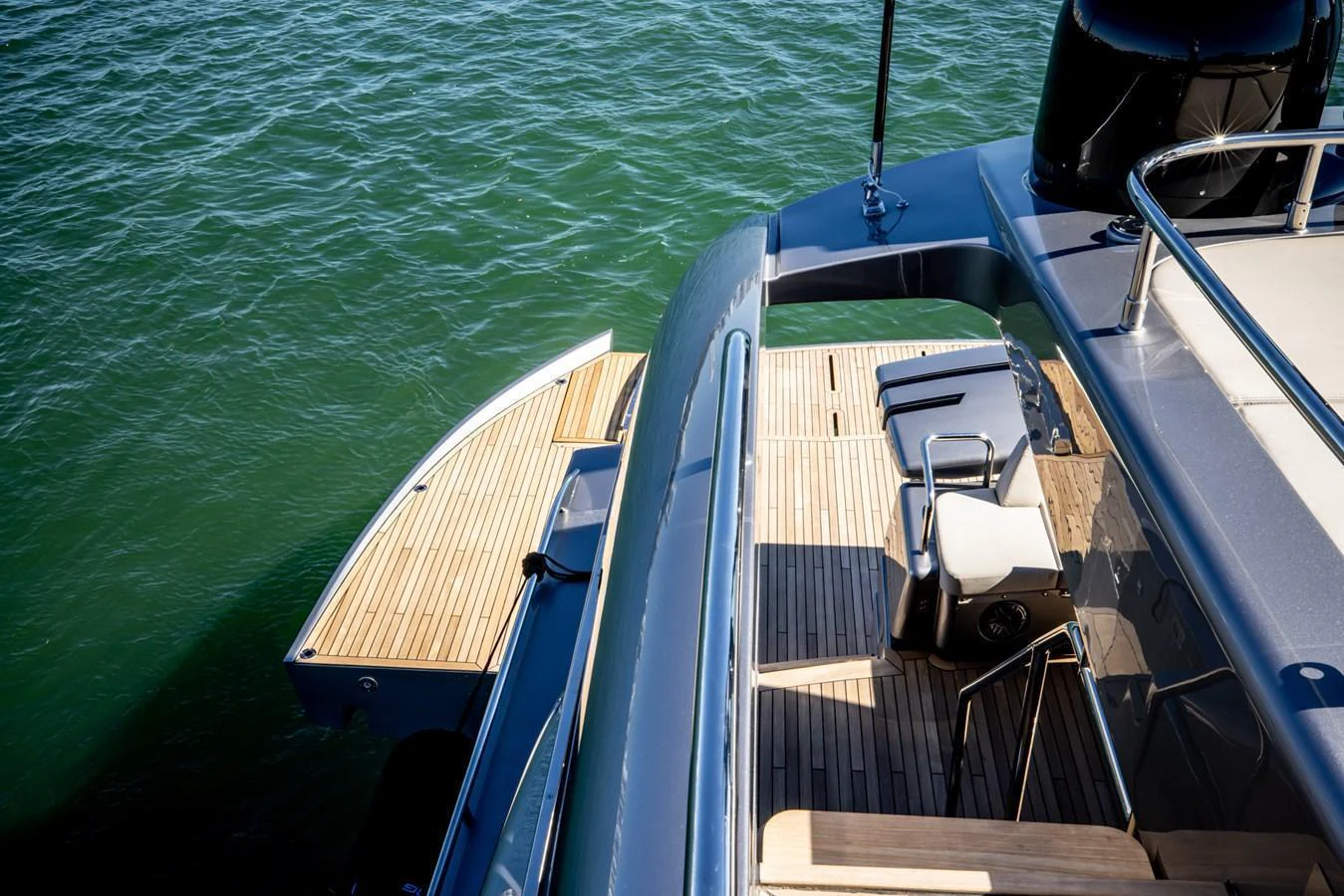 The yacht's aft deck features a sleek design with a spacious swim platform and comfortable seating area. aboard CIAO Yacht for Sale