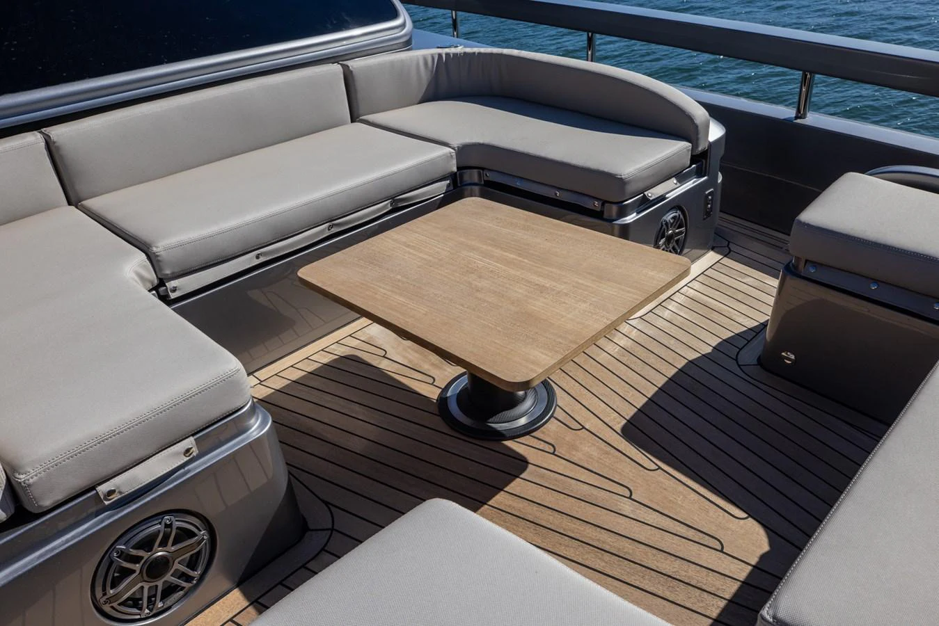 The aft deck features comfortable seating and a central wooden table, perfect for socializing and relaxation. aboard CIAO Yacht for Sale
