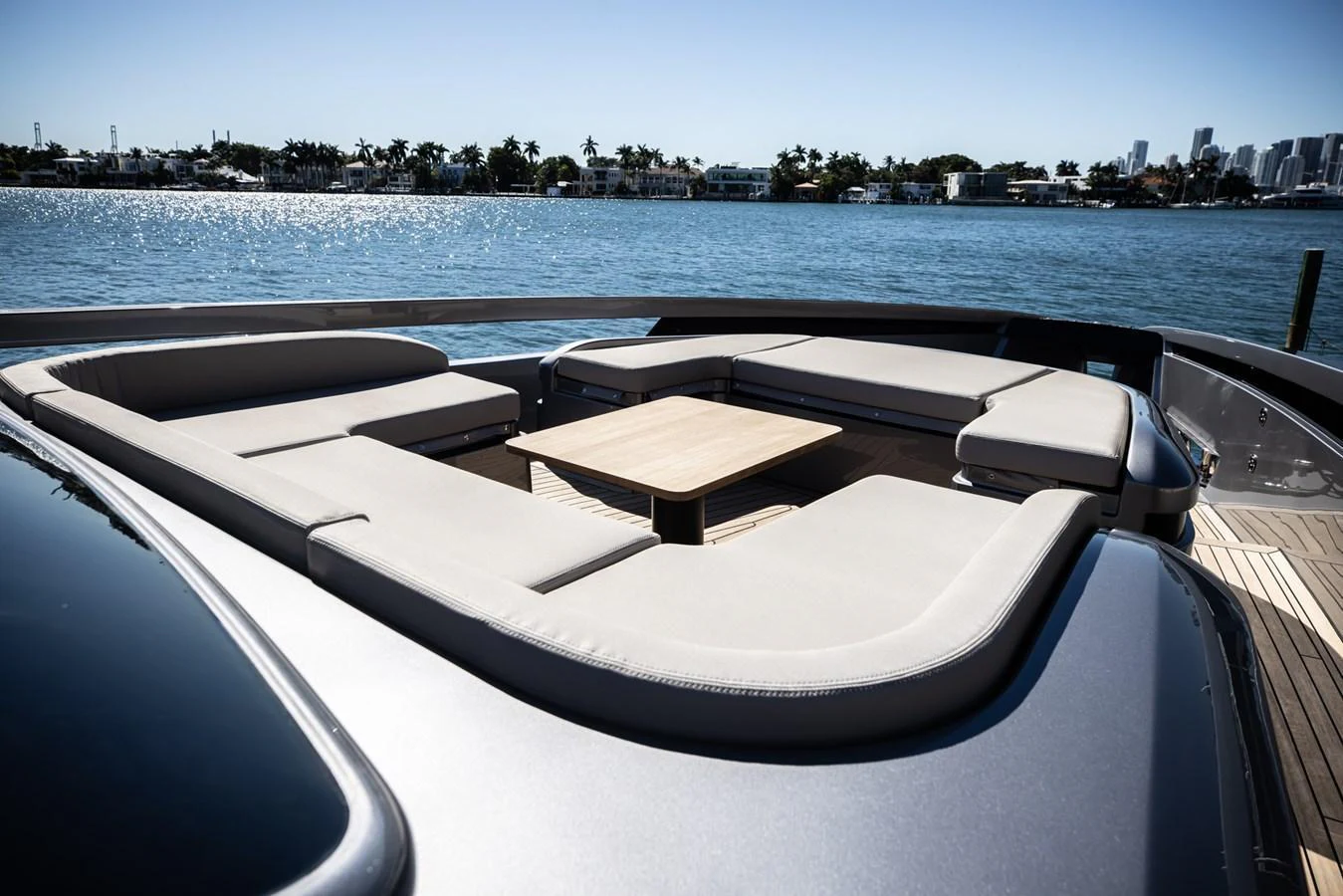 The aft deck features a spacious and stylish seating area with a central table, perfect for relaxation and socializing. aboard CIAO Yacht for Sale
