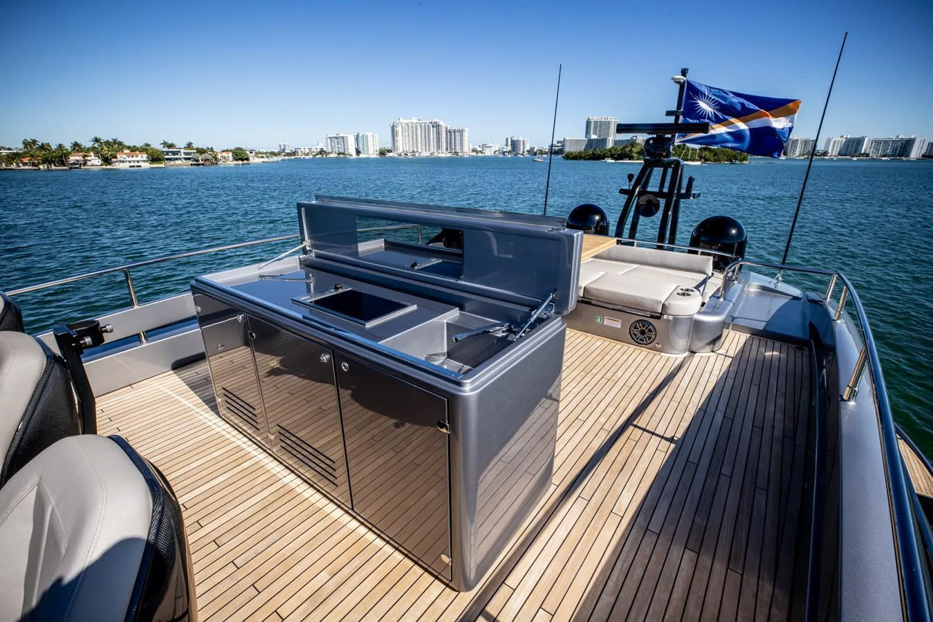 The flybridge offers a spacious area with a sleek outdoor kitchen and comfortable seating, perfect for enjoying the view. aboard CIAO Yacht for Sale