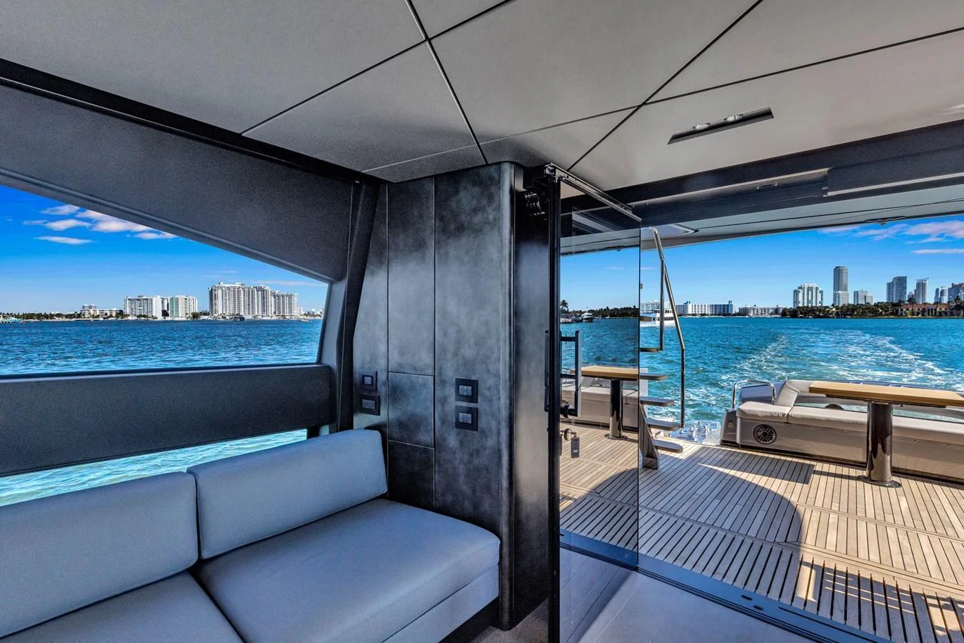 The modern salon opens up to a spacious aft deck with stunning views of the city skyline. aboard CIAO Yacht for Sale