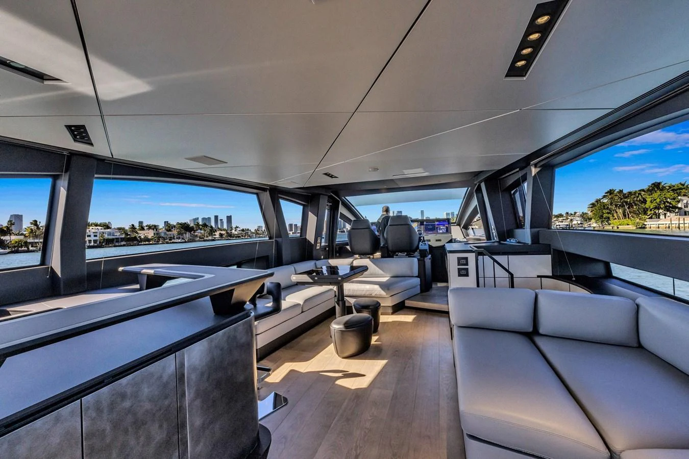 The yacht's salon features modern furnishings and expansive windows offering panoramic views. aboard CIAO Yacht for Sale