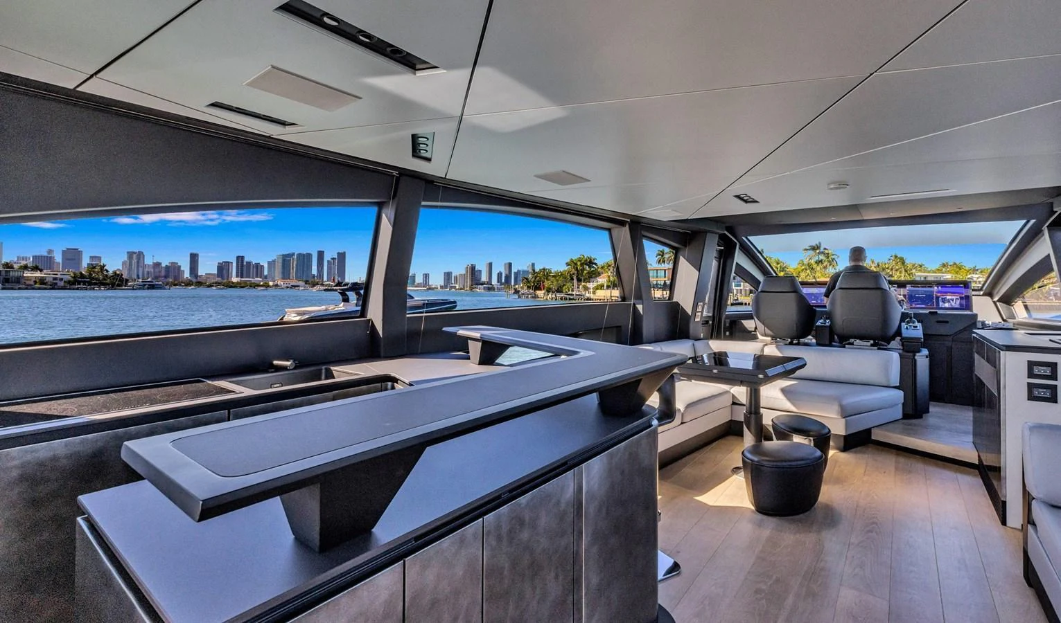 The yacht's salon offers a modern and spacious area with panoramic views of the city skyline. aboard CIAO Yacht for Sale