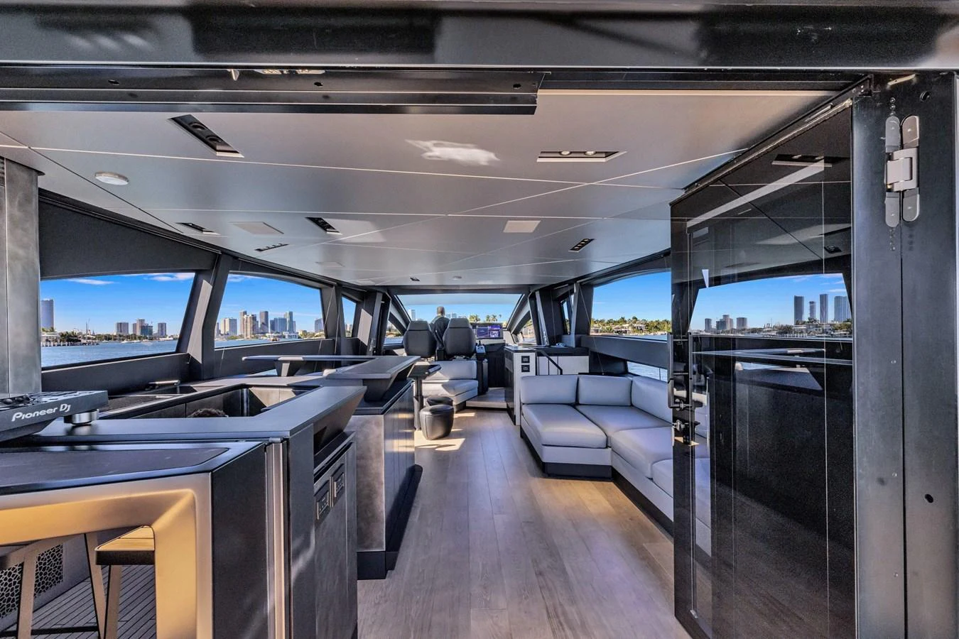 The yacht's salon features modern furnishings with panoramic windows offering stunning views. aboard CIAO Yacht for Sale