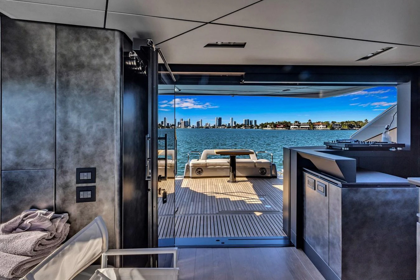 The salon opens up to a stunning aft deck with a beautiful waterfront view. aboard CIAO Yacht for Sale
