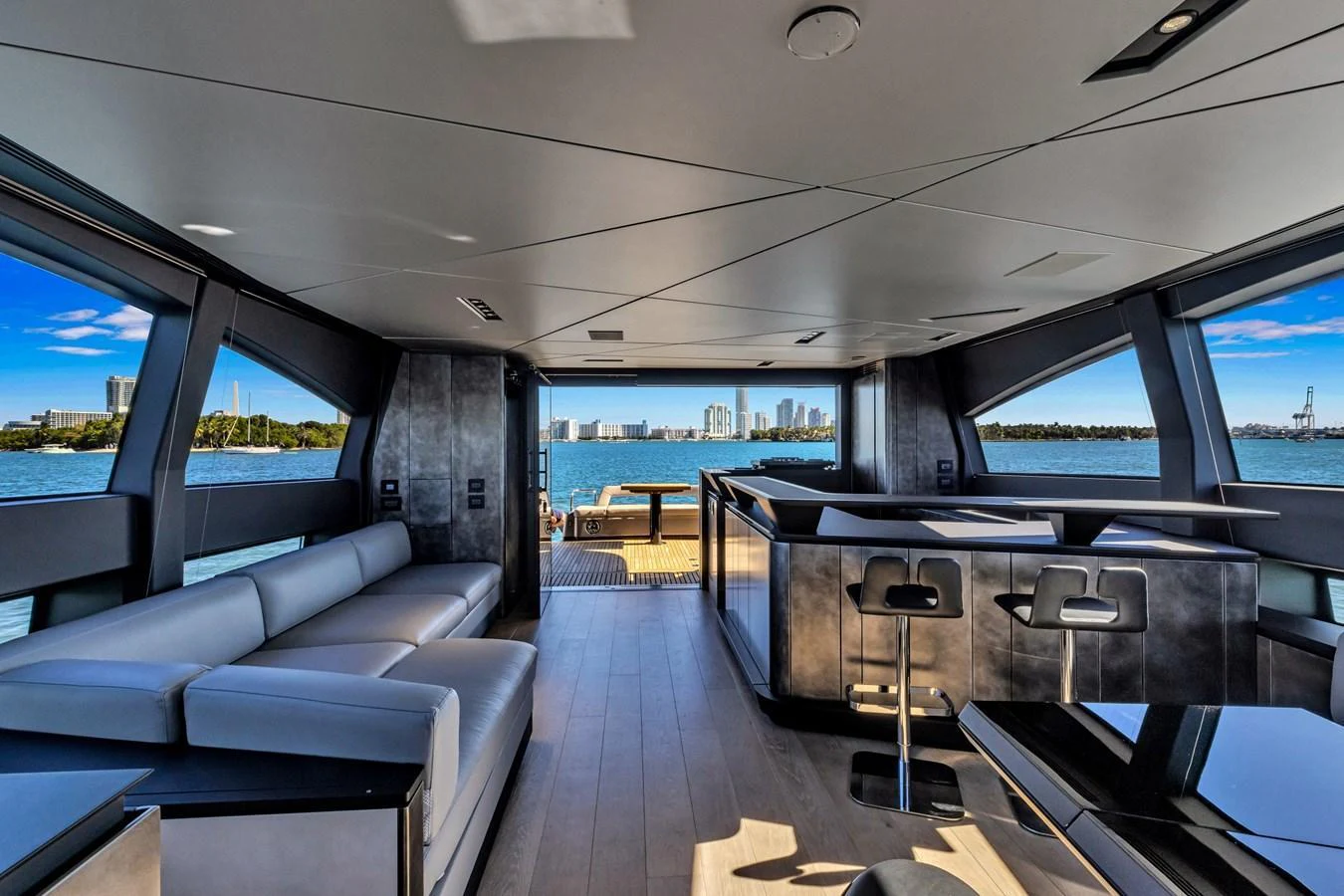 The yacht's salon features modern furnishings and expansive windows offering stunning water views. aboard CIAO Yacht for Sale