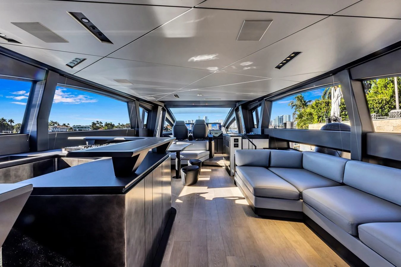 The yacht's salon features modern furnishings with panoramic windows offering stunning views. aboard CIAO Yacht for Sale