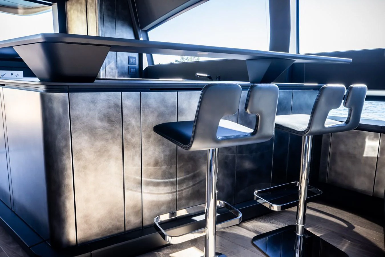 The sleek and modern galley features stylish bar stools and a contemporary design. aboard CIAO Yacht for Sale