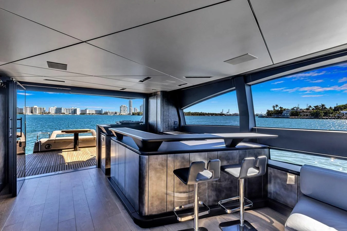 The salon offers a modern, open layout with panoramic views and sleek furnishings. aboard CIAO Yacht for Sale