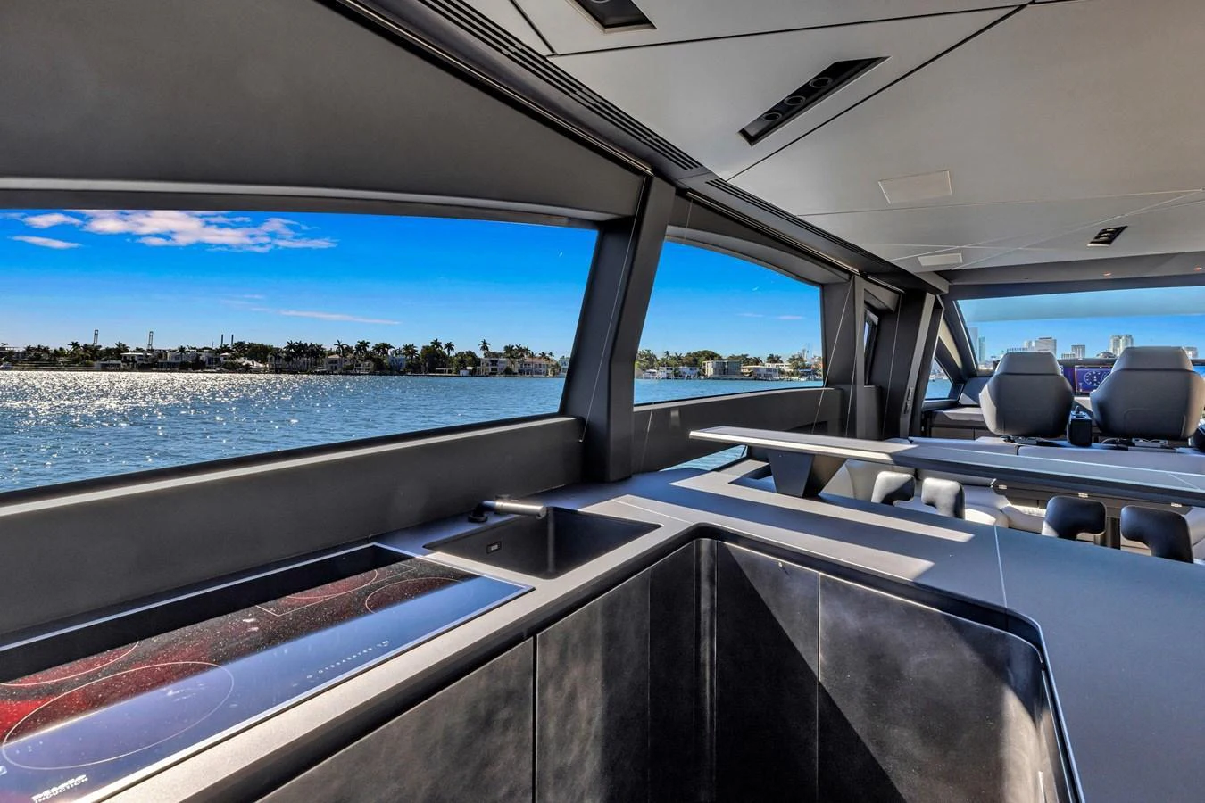 The sleek and modern galley offers stunning views of the water through large windows. aboard CIAO Yacht for Sale
