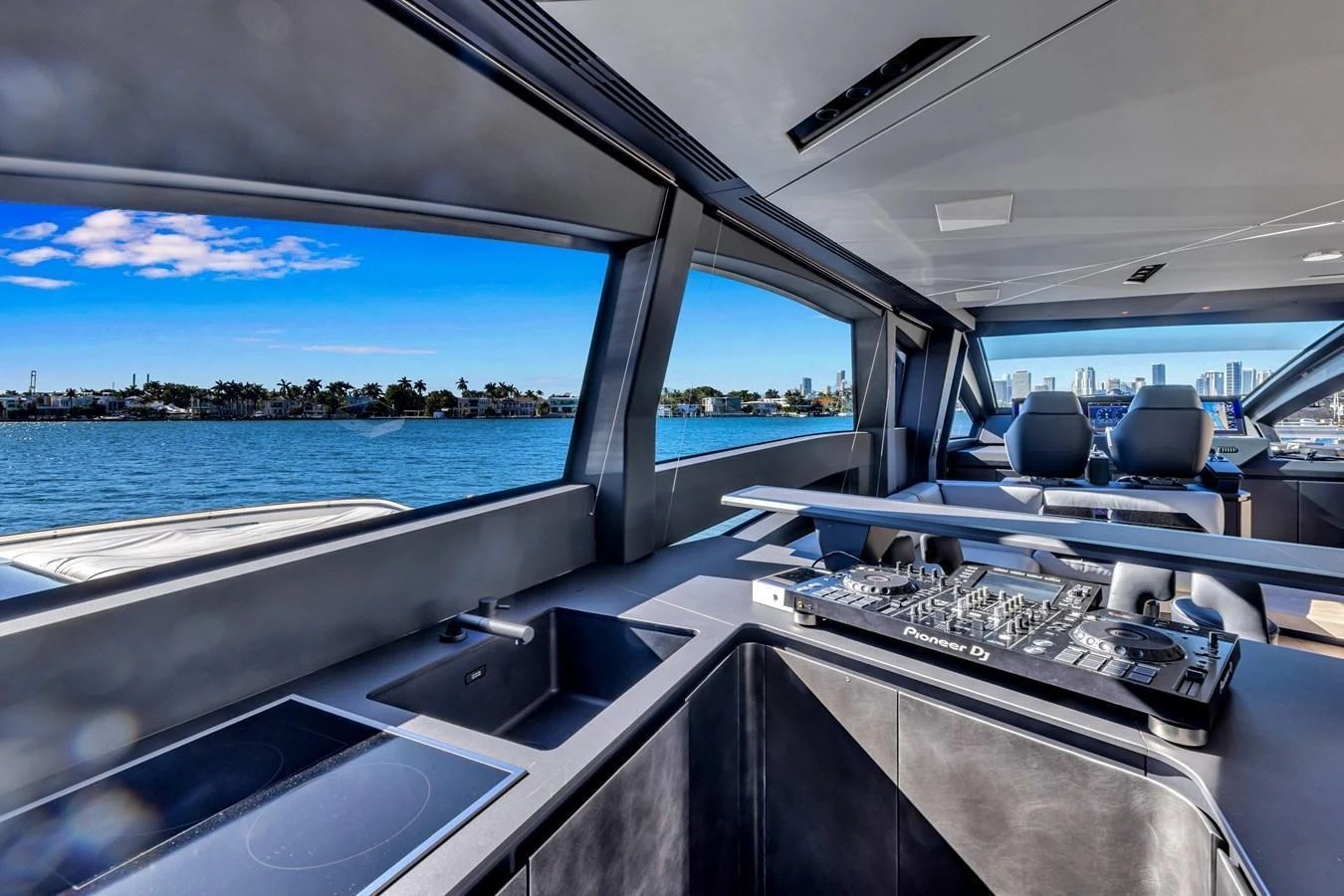 The helm area features modern controls and panoramic windows offering stunning water views. aboard CIAO Yacht for Sale