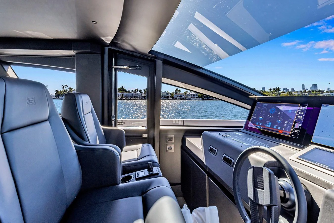 The helm of the yacht features modern controls and luxurious seating with a panoramic view. aboard CIAO Yacht for Sale