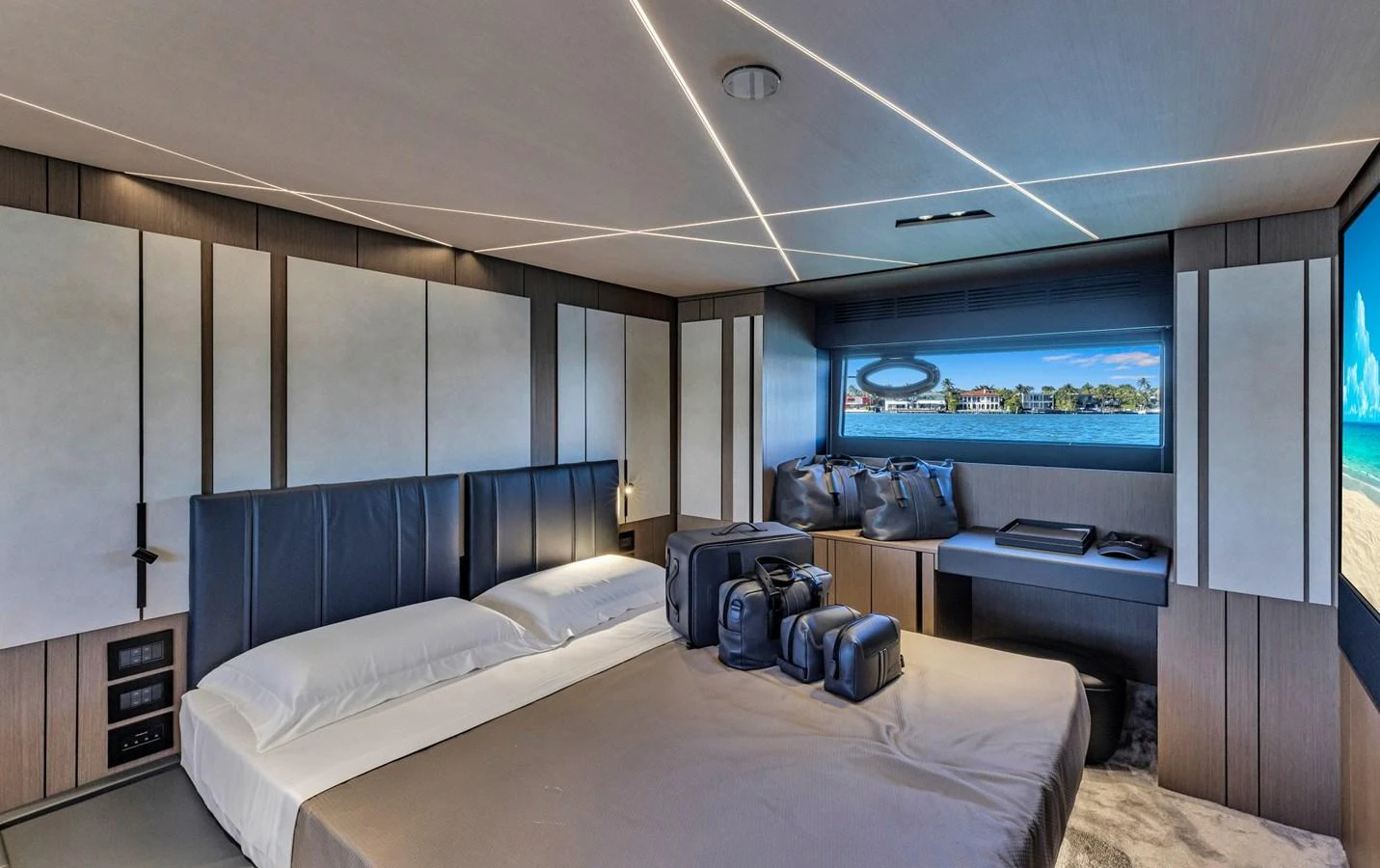 A luxurious stateroom with modern design and a scenic view through the window. aboard CIAO Yacht for Sale
