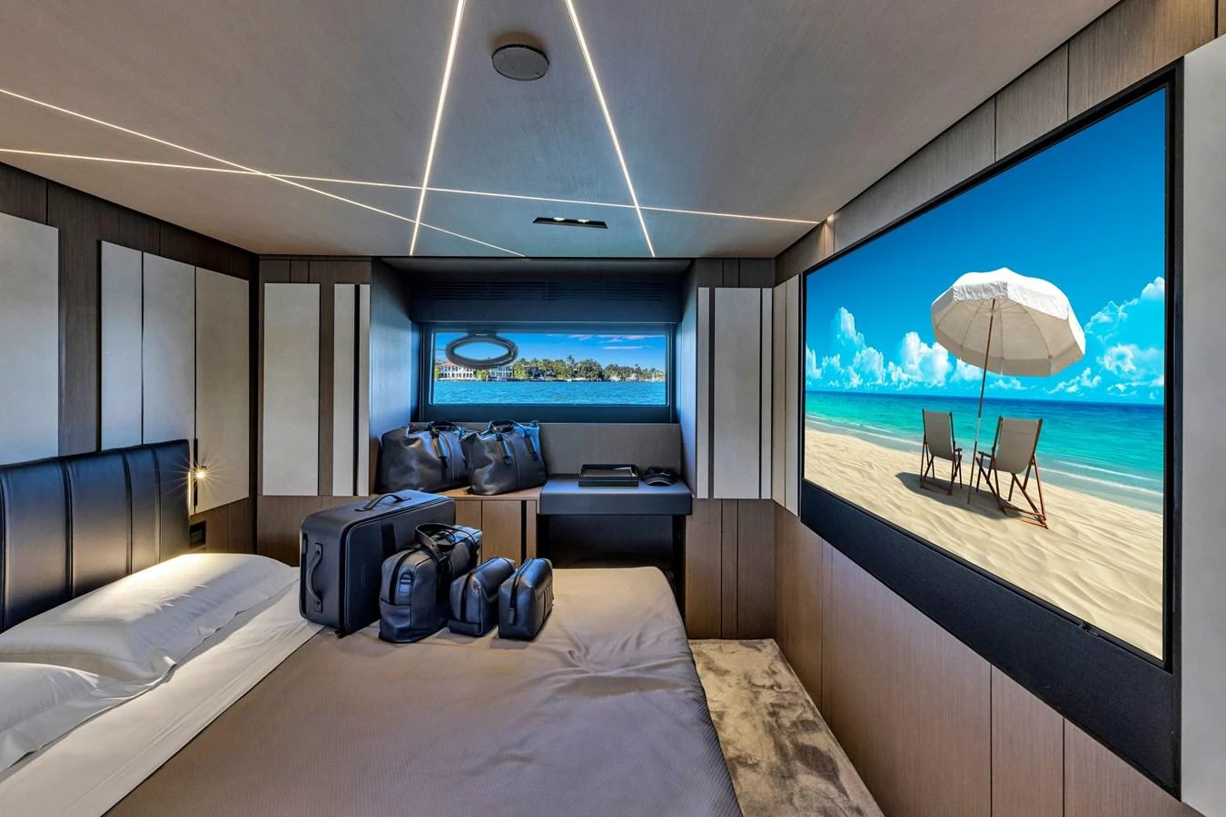 A luxurious stateroom featuring a large bed, modern decor, and a scenic view displayed on a screen. aboard CIAO Yacht for Sale