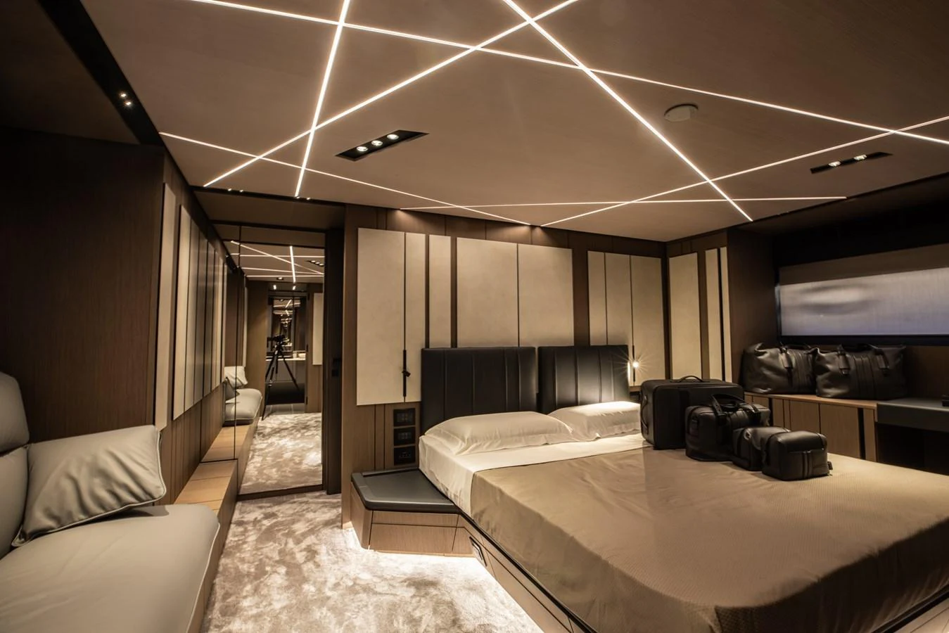 The master stateroom features a luxurious bed, modern lighting, and ample storage space. aboard CIAO Yacht for Sale