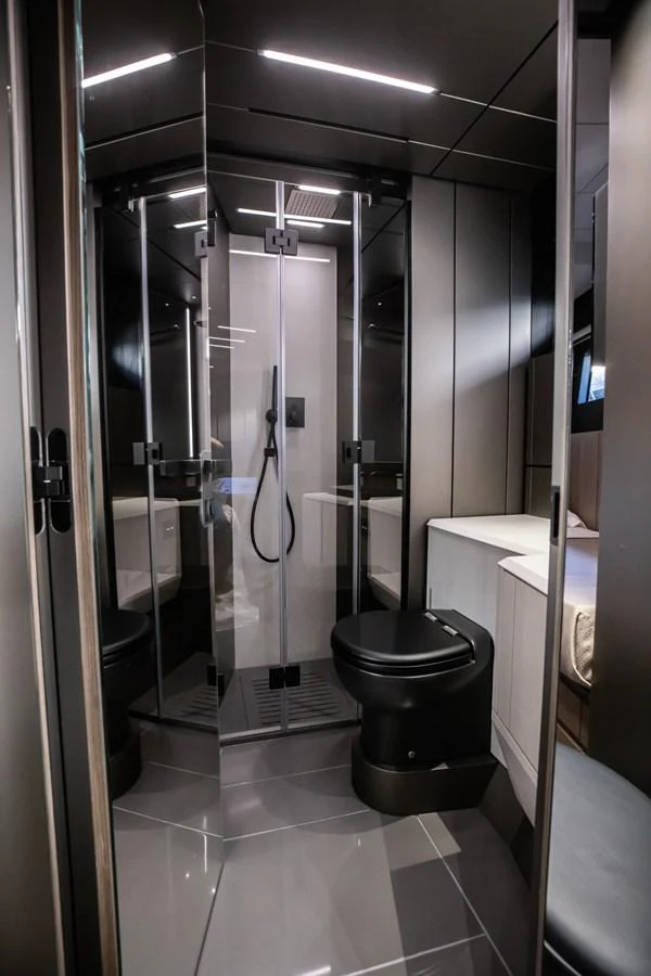 The yacht's bathroom features sleek, modern design with a glass-enclosed shower and contemporary fixtures. aboard CIAO Yacht for Sale
