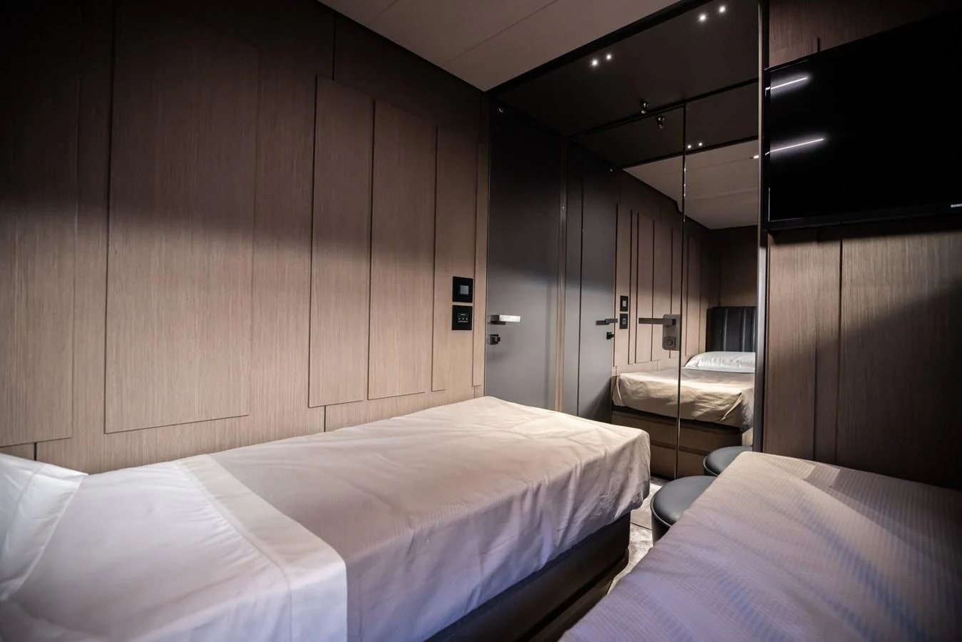 The twin stateroom offers a cozy and modern sleeping area with sleek finishes. aboard CIAO Yacht for Sale