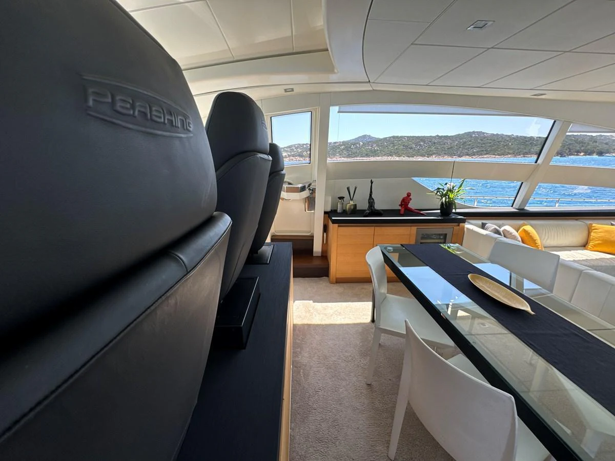 The salon features a sleek dining area with panoramic views of the sea. aboard THYKE III Yacht for Sale