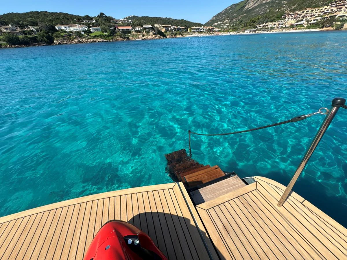 A serene view from the yacht's swim platform, showcasing the inviting turquoise waters. aboard THYKE III Yacht for Sale