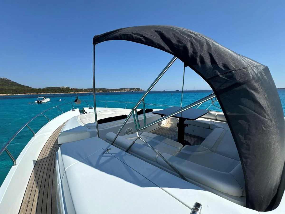 The yacht's sundeck offers a luxurious space for relaxation with stunning views of the turquoise waters. aboard THYKE III Yacht for Sale