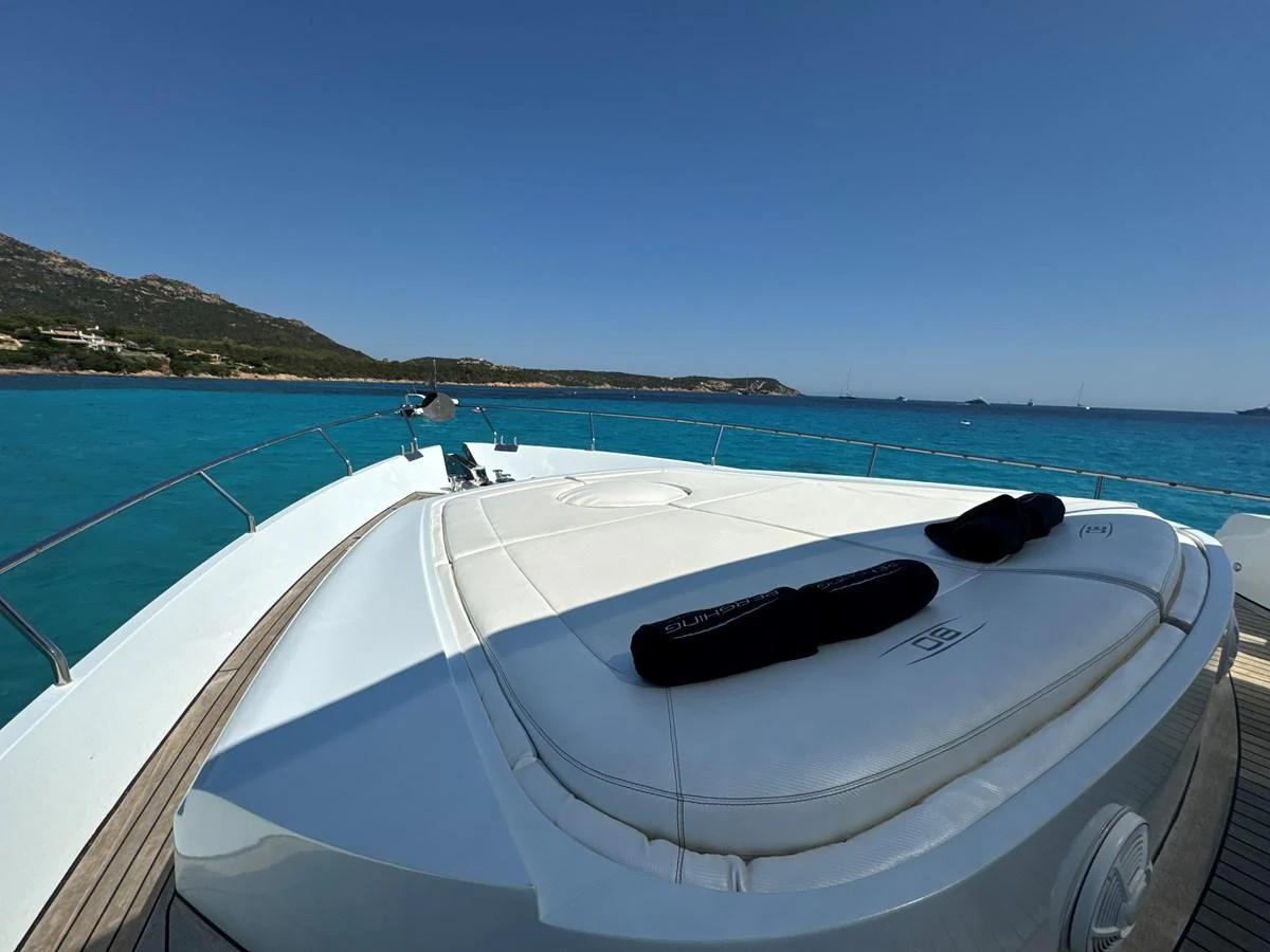 The yacht's foredeck features a spacious sunpad with stunning views of the turquoise waters. aboard THYKE III Yacht for Sale