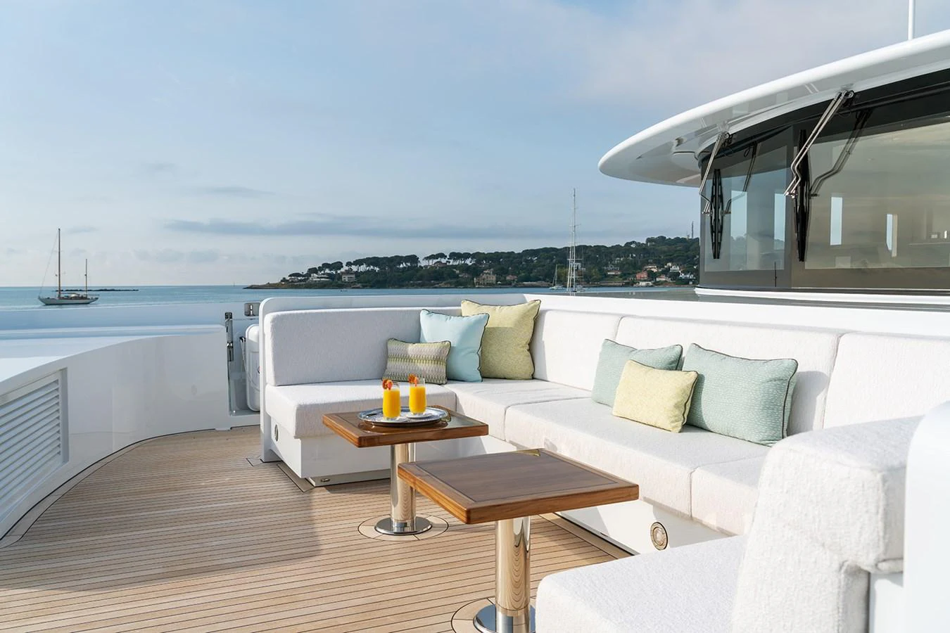 The aft deck features a comfortable seating area with a stunning view of the sea. aboard SOLEMATES Yacht for Sale