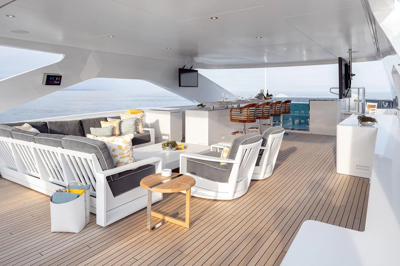 The sundeck offers a luxurious outdoor lounge area with comfortable seating and a bar, perfect for relaxation and entertainment. aboard SOLEMATES Yacht for Sale