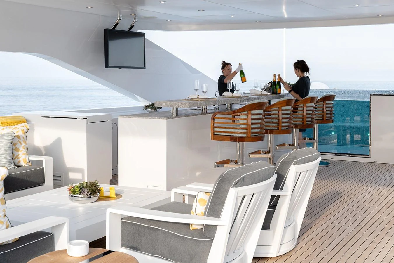 The yacht's bar area offers a luxurious setting with comfortable seating and a stunning ocean view. aboard SOLEMATES Yacht for Sale