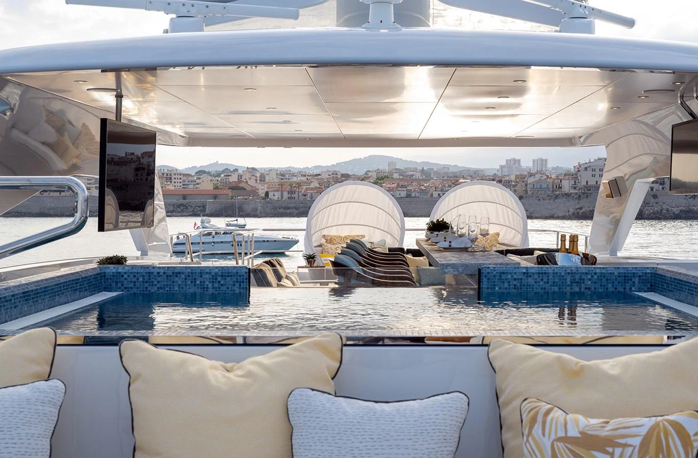 The sundeck features a luxurious pool with comfortable lounging areas and scenic views. aboard SOLEMATES Yacht for Sale
