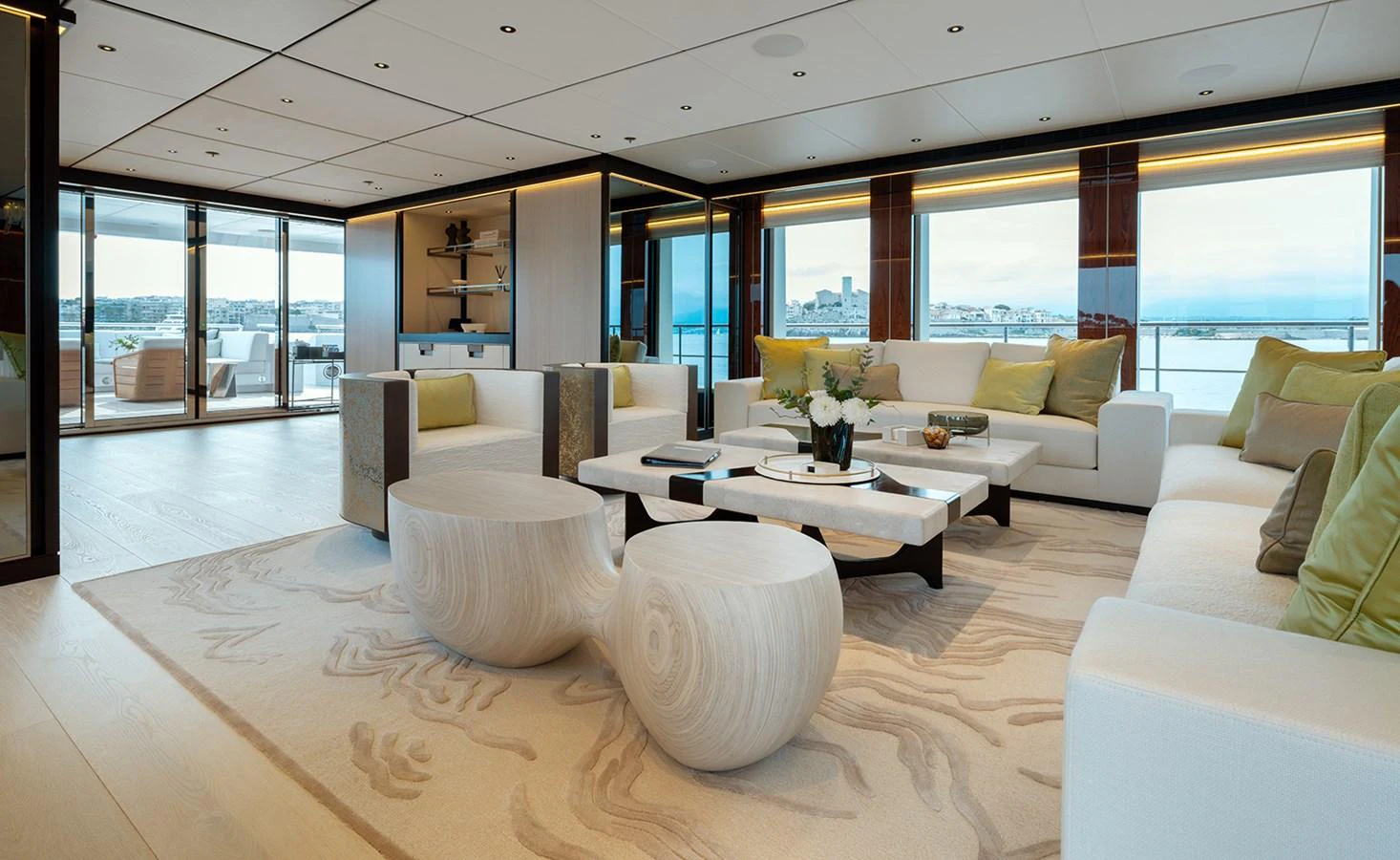 The yacht's salon features modern furnishings and large windows offering panoramic views. aboard SOLEMATES Yacht for Sale