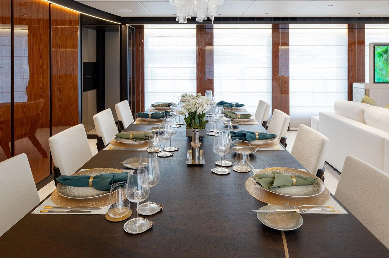 The elegant dining area features a beautifully set table with luxurious tableware and comfortable seating. aboard SOLEMATES Yacht for Sale