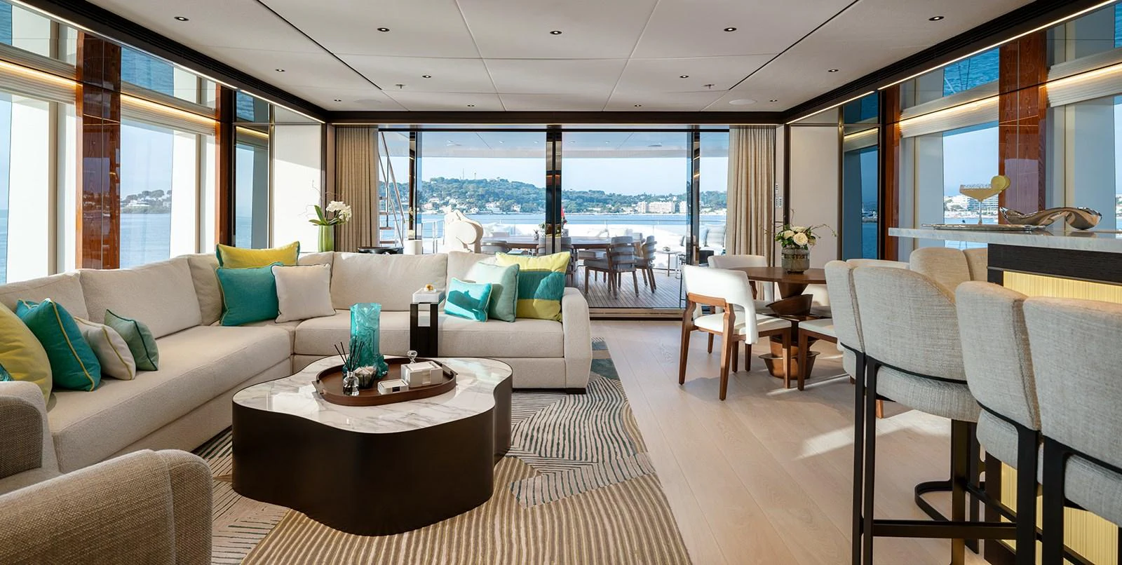 The spacious salon features elegant furnishings and panoramic views, creating a luxurious and inviting atmosphere. aboard SOLEMATES Yacht for Sale
